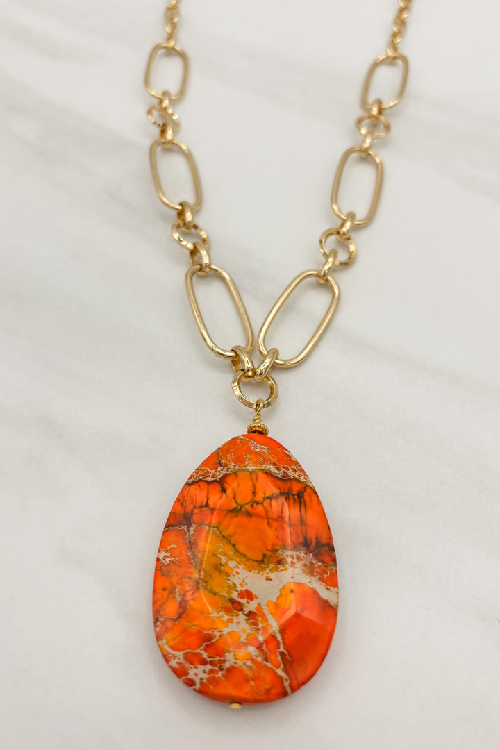 Orange Tear Drop Pendant on a Long Gold Necklace