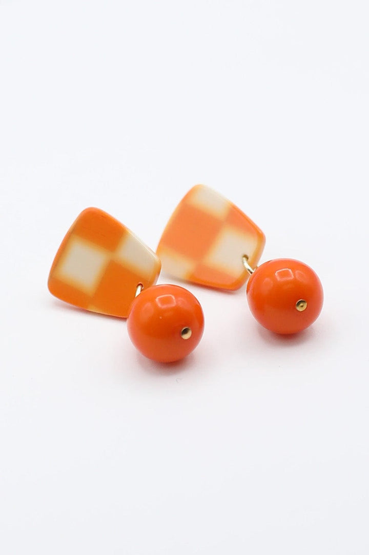 Checkerboard Earrings With Dangling Solid Orange Teardrop Accent Bead