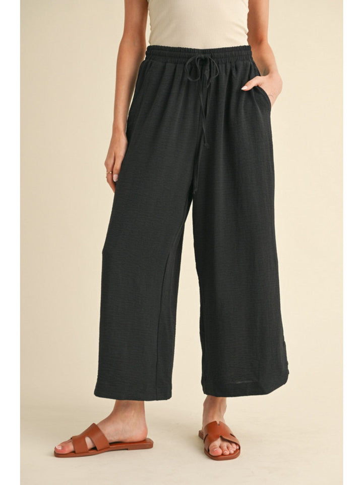 Jodifl Flowy Lightweight Loose Fit Drawstring Waist Pants with Button Detailing at Hem